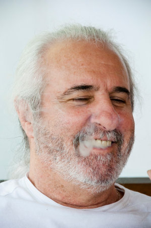 happy senior hispanic face. Wise Hispanic elder. Respected Hispanic senior. Distinguished cuban gentleman. man portrait face. mature gray hair and beard. portrait of hispanic old man.の写真素材