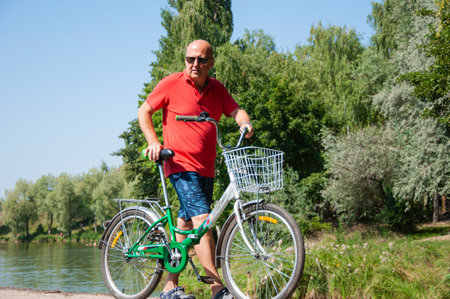 cyclist with sport bike outdoor. summertime activity recreation and active lifestyle. weekend travel and adventure. leisure and fun of man. man with bicycle in summer.の写真素材