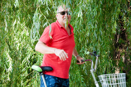 man with bicycle in summer. cyclist with sport bike outdoor. summertime activity recreation and active lifestyle. weekend travel and adventure. leisure and fun of man.の写真素材