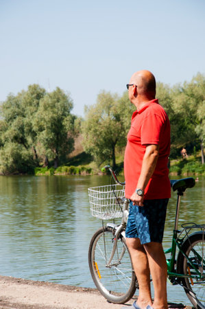leisure and fun of man. man with bicycle in summer. cyclist with sport bike outdoor. summertime activity recreation and active lifestyle. weekend travel and adventure. copy space banner.の写真素材