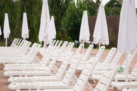deck chairs at rest zone. summer beach holiday. summertime lifestyle. outdoor resort at poolside. pool sunbed and sun lounger.の写真素材