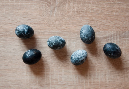 easter egg. happy easter. sunday spring holiday. bunny hunt begin. egg hunting. traditional galaxy painted eggs on wood table. minimalist design. hunting eggs in springtime. spring eastertime holiday.の写真素材