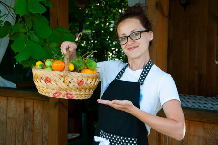 woman farmer with vegetable harvest. organic food and eco farming. greengrocer woman outdoor. harvester or gardener. summer harvesting. autumn vegetable harvest. agriculture crop. best offer.の写真素材