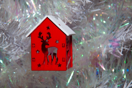 Christmas tree decoration. Decoration for New Year holiday celebration. Happy New Year. Christmas Tree Background. Beautiful Christmas gift near fir tree in room. Festive Christmas scene. House.の写真素材