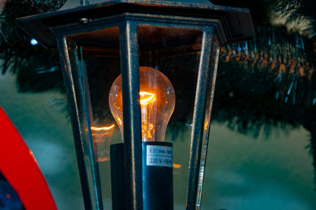 Streetlight lantern. Lantern for street. Lantern with light on. Street lamp bulb.