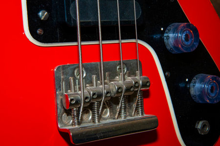 Electric bass guitar red color with string on fingerboard for rock music.