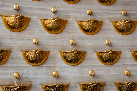 Golden fountain with gold bowl for water flow. Fountain golden decoration of city architecture. Architecture of Kyiv. Architectural design. Fountain of desires. Luxury architecture.の写真素材