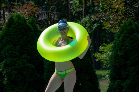 Summertime vacation. Girl in swimming suit in water. Free time and day off. Relax. Relaxing while swimming. Summer spa resort vacation. Woman in swimming pool. Pool party. Summer mood.の写真素材