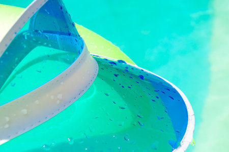 Drops of water on cap. Relaxing at the pool. Summer resort vacation. Inflatable ring in swimming...