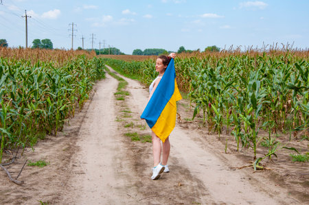 Ukrainian flag patriotic woman. Flag Ukraine. Independence day. Woman countryside road. Girl with...