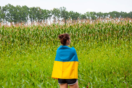 24th of August. Ukrainian flag and woman farmer. Flag Ukraine. Independence day. Woman in the field....