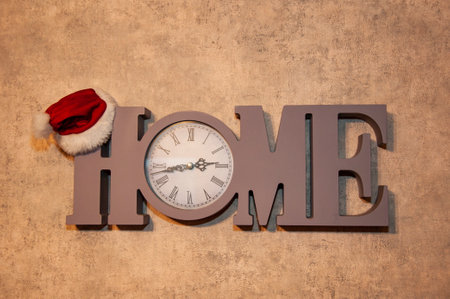 Countdown clock with Santa hat. Home clock. Christmas time. Home goods for Xmas. Holiday sale. Xmas shopping time. Christmas home decoration. Santa Claus. Happy new year 2025. Party time.の写真素材