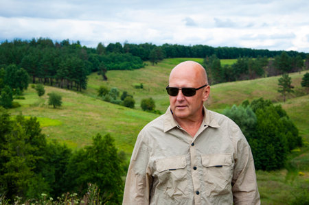 Mountain travelling. Hiking and camping. Adventure at scenic location. Man at valley landscape peak. Man bold in autumn style at nature landscape. Travel portrait of man. Exploring valley.の写真素材