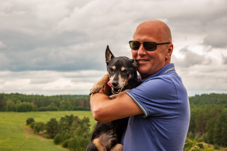 Pet companion for man. Travel with pet. Dog companion. Man and canine friend. Leisure and bonding concept. Happy life portrait. Always together. Walking and training. Morning walk.の写真素材