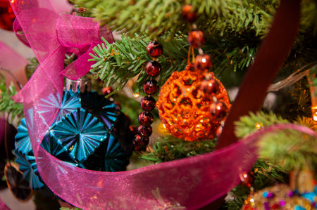 Xmas party 2026. Christmas tree decoration at home for Xmas with colorful decor and lights.の写真素材