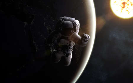 Astronaut in outer space. Sun and Earth. Image in 5K resolution for desktop wallpaper.の写真素材