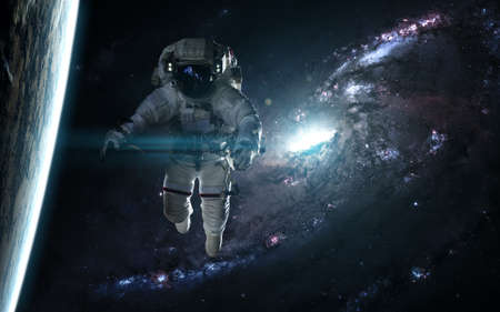 Astronaut and planet against a blue galaxy. Abstract science fiction. Image in 5K for desktop...