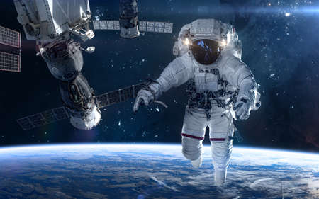 Astronaut, space station in deep space. Beautiful cosmic landscape. Science fiction. Elements of this image furnished by NASAの写真素材