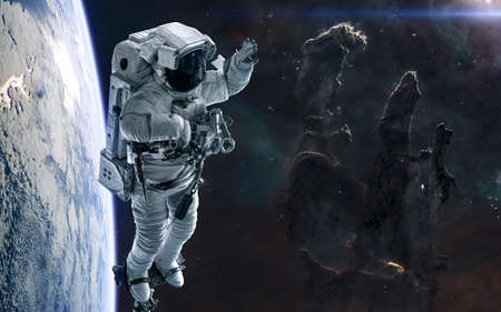 Pillars of Creation, astronaut, planet in deep space. Science fiction.