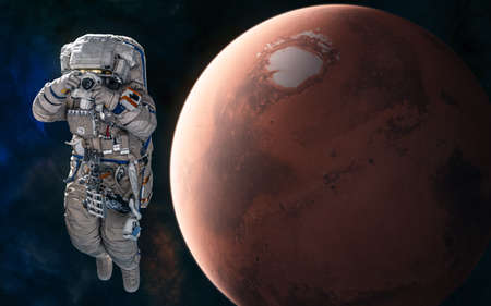 Astronaut on background of Mars. Red planet of the solar system. Science fiction.の写真素材
