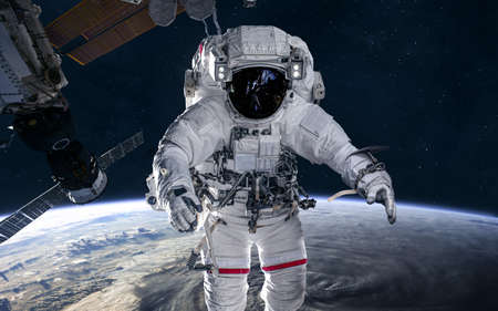 Astronaut and  station in orbit of the Earth. Solar system. Science fiction. Elements of this image...