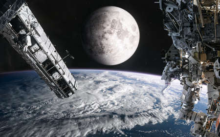 Space stations on background of the moon. View from the orbit of Earth. Solar system. Science fiction.の写真素材