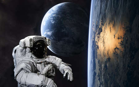 Astronaut on background of planets in deep space. Science fiction.の写真素材