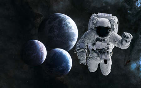 Astronaut on background of planets in deep space. Science fiction.