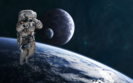 Astronaut on background of planets in deep space. Science fiction.の写真素材