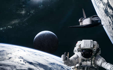 Astronaut, space shuttle, planets in deep space against backdrop of spiral galaxy. Science fiction.