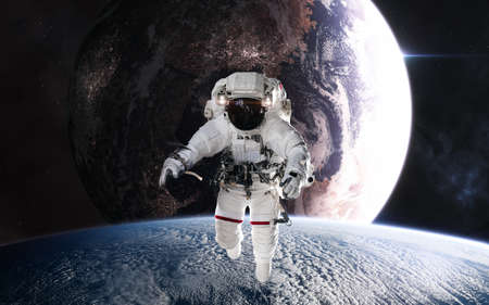 Astronaut in outer space in planetary orbit. Inhabited planet in deep space. Science fiction....