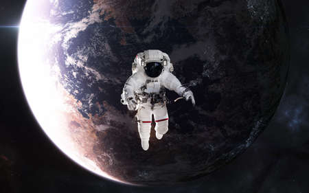 Astronaut in outer space. Inhabited planet in deep space. Science fiction.の写真素材