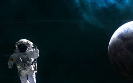Astronaut, planet of deep space against background of nebulae. Science fiction.