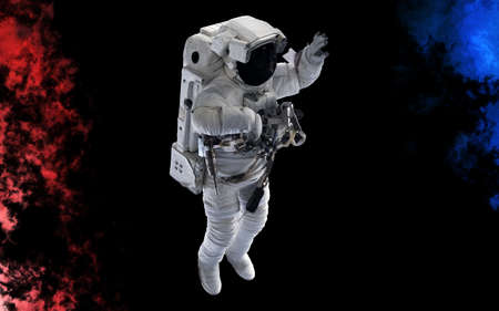 Astronaut isolated on a black background. Dust splash in space style. Science fiction.の写真素材