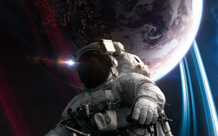 Astronaut in outer space in front of distant inhabited planet. Science fiction. Elements of this image furnished byの写真素材