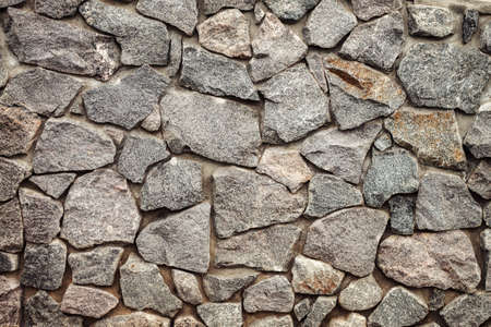 pattern gray color of stone wall surface with cement. Old stone wall