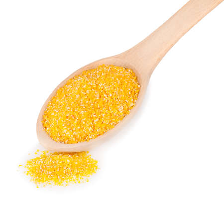 wooden spoon with corn grits isolated on white background.の写真素材