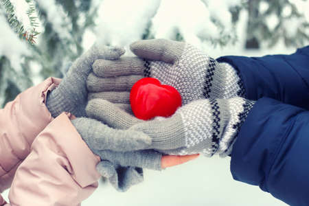 Hands holding red heart outdoorの写真素材