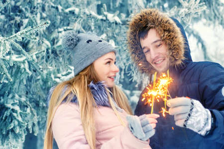 couple with sparklers in winterの写真素材