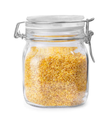 bulgur in glass jar isolated on whiteの写真素材