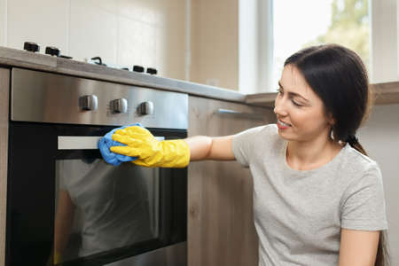 woman cleaning ovenの写真素材