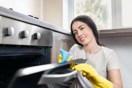 woman cleaning kitchenの写真素材