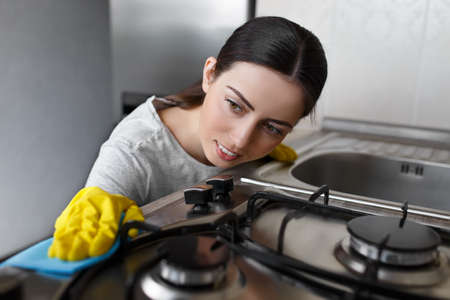 woman cleaning stoveの写真素材