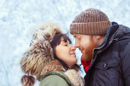 couple hugging outdoors in winterの写真素材