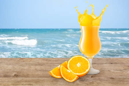 orange juice on the beach tableの写真素材