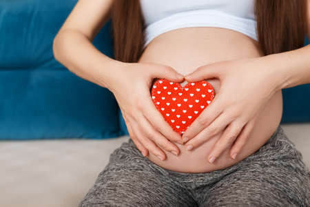 pregnant woman with heart on belly