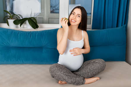 happy pregnant woman with appleの写真素材