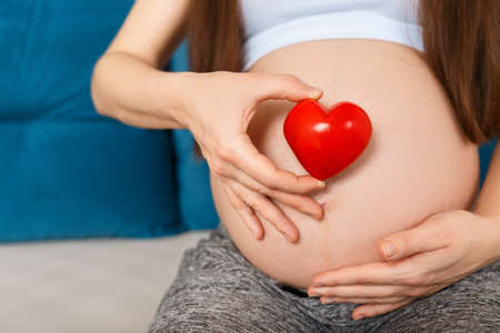pregnant woman with heart on bellyの写真素材