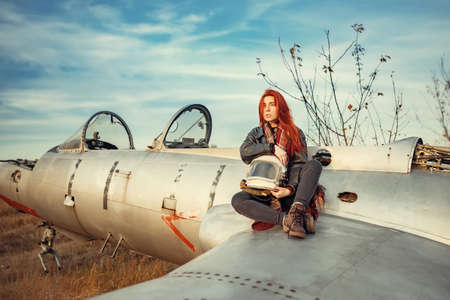 redhead girl in black leather jacket and helmet