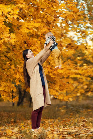 mother with son in autumn parkの写真素材